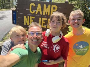 Brian with his three children at camp